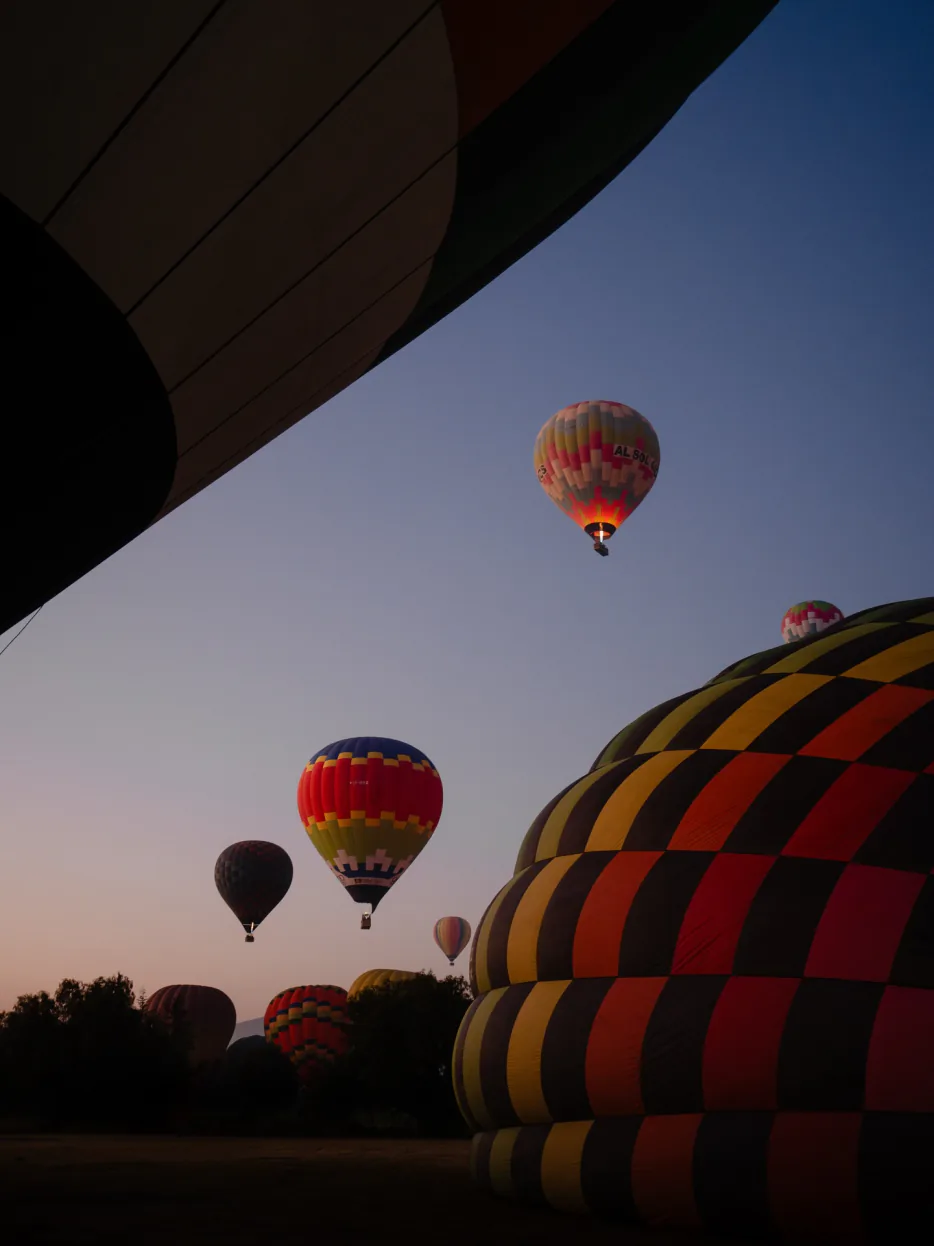 Globos aerostáticos inflados en la zona de despegue de Teotihuacán al amanecer